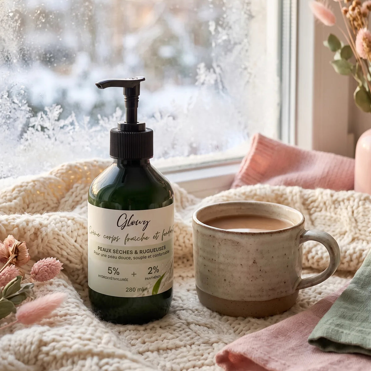 Crème hydratante corps Glowy pour peau très sèche en hiver, posée sur un plaid en maille