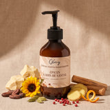 Crème mains Glowy entourée de ses ingrédients : beurre et fèves de cacao, tournesol, cardamome, poivre rose, gingembre et bois de santal